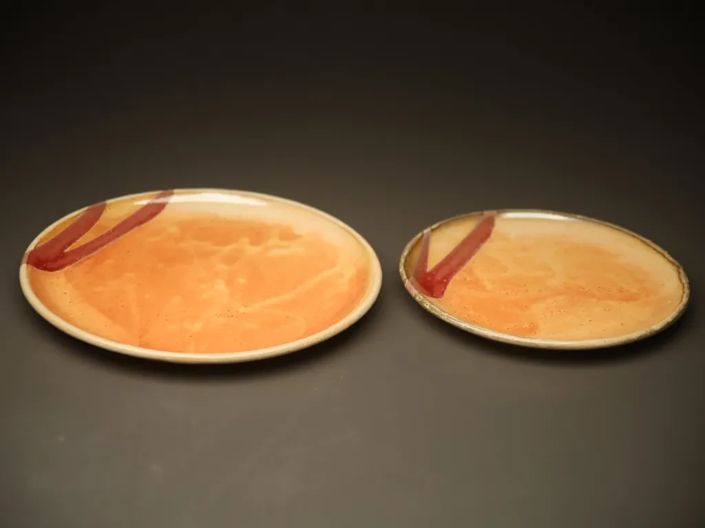 Glazed soneware plate with red accents
