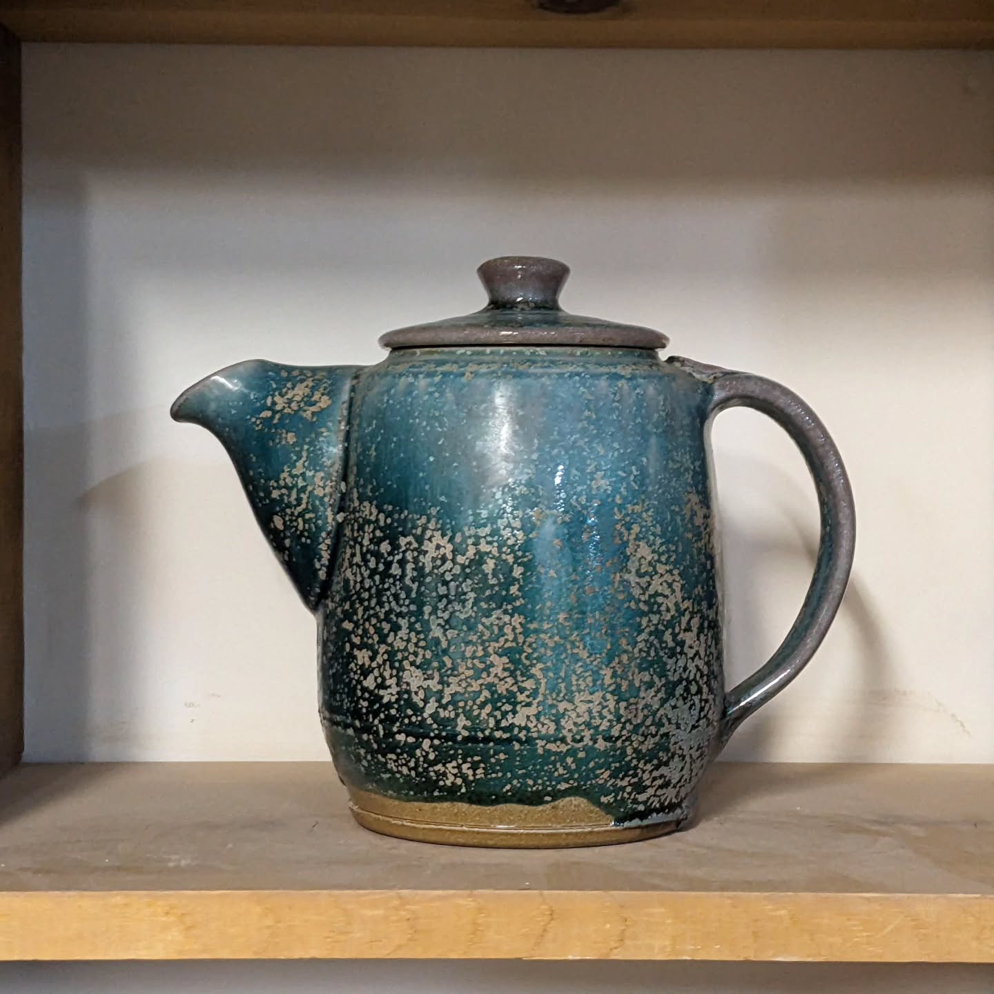 Salt-fired Teapots on shelves