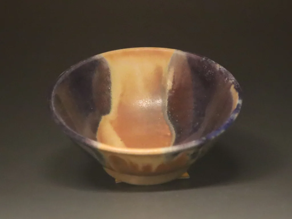 Purple and beige reduction-fired bowl