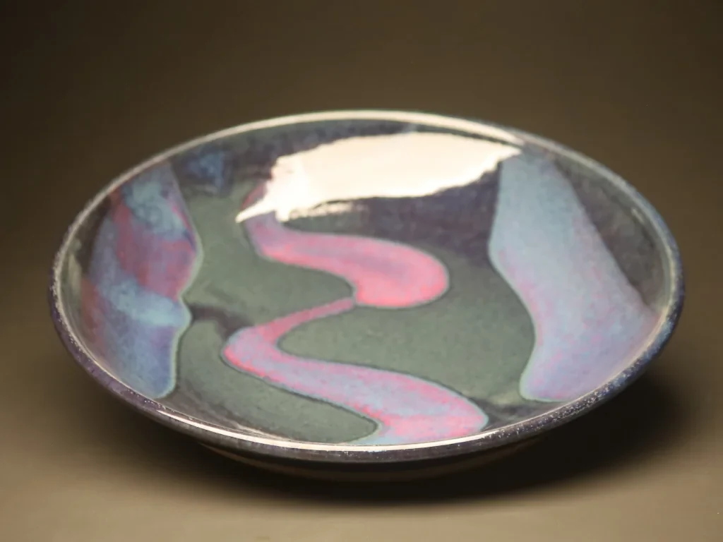 Blue-variegated reduction bowl with pink slip accent
