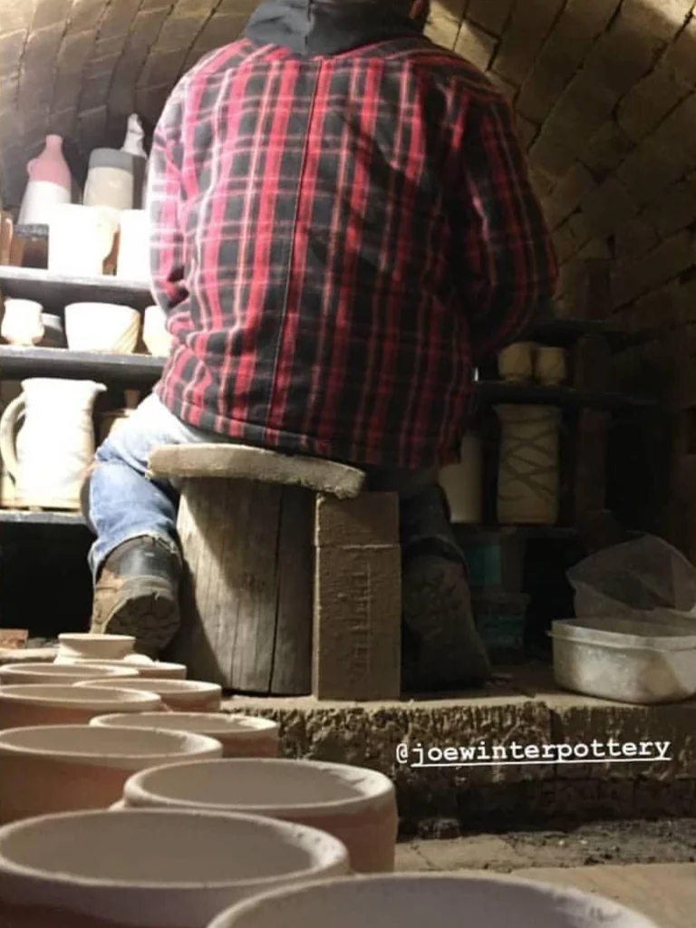 Loading pottery into a kiln before firing