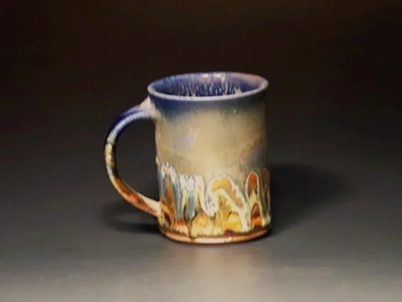 Salt-fired mug with blue drip to copper glaze