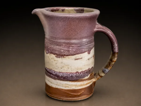 Purple, tan, and copper striped pitcher